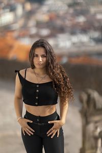 Portrait of a beautiful young woman standing outdoors