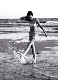 Woman jumping in sea