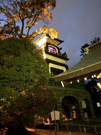 Low angle view of illuminated building against sky