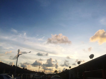 Low angle view of silhouette buildings against sky