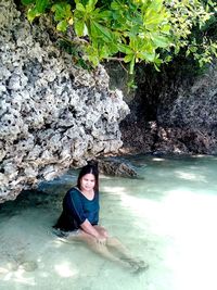 Portrait of smiling young woman in water