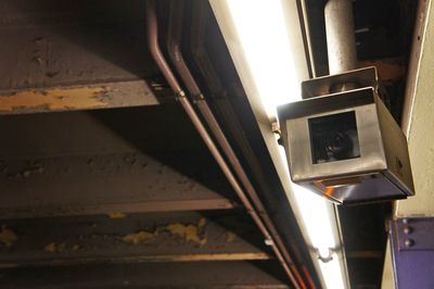 Close-up of electric lamp on railing at home