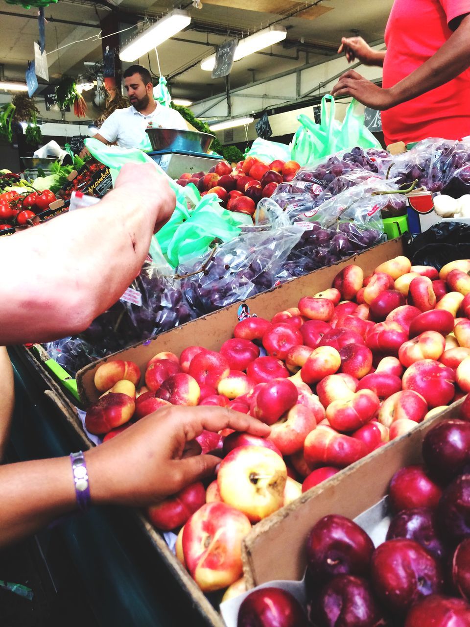 food and drink, food, holding, lifestyles, freshness, fruit, leisure activity, healthy eating, person, high angle view, market, retail, market stall, for sale, men, variation