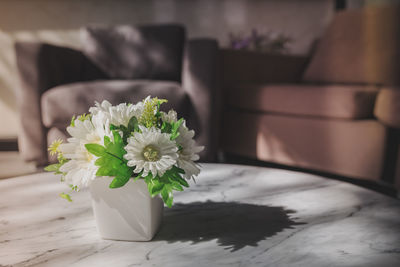 Close-up of white flower vase on table at home