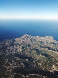 High angle view of sea and land against sky