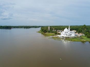 Scenic view of lake by building against sky