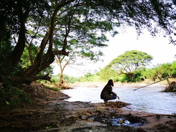 Man sitting on horse against trees