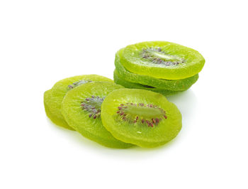 Close-up of green fruit against white background