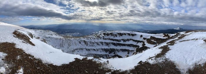 Scenic view of snowcapped mine in mountains