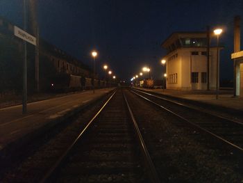 View of illuminated railroad tracks at night