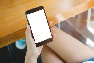 Low section of person holding smart phone