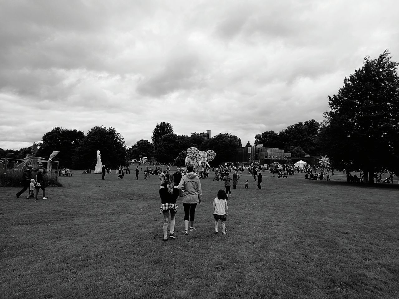 sky, large group of people, tree, cloud - sky, cloudy, men, person, leisure activity, lifestyles, cloud, togetherness, mixed age range, park - man made space, field, landscape, day, grass, outdoors, nature