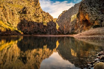 Scenic view of lake and mountains against sky