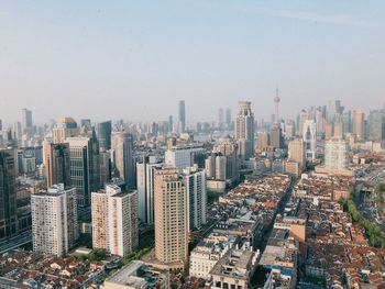 High angle view of modern buildings in city against sky