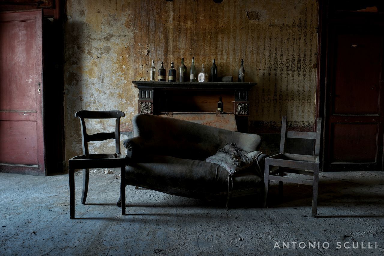 CHAIRS AND TABLE IN ABANDONED HOUSE