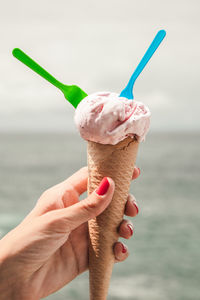 Hand holding ice cream cone