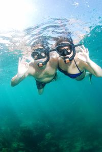 Portrait of couple swimming in sea