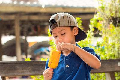 Close-up of boy eating corn