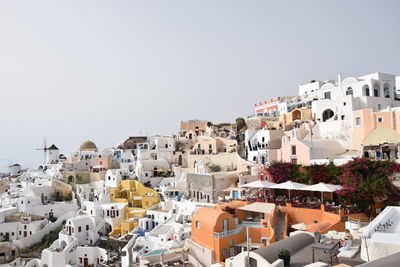 Houses in town against clear sky