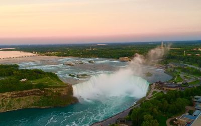 High angle view of waterfall against sky during sunset