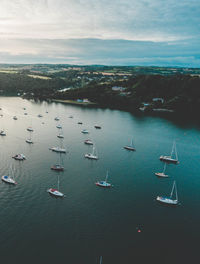 High angle view of boats moored at harbor against sky