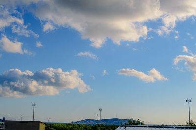 Low angle view of street against blue sky