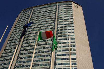 Low angle view of flag against buildings in city