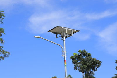 Low angle view of street light against blue sky