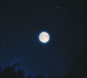 Low angle view of moon against sky at night