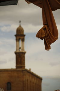 Low angle view of cross against sky