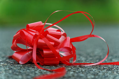Close-up of red ribbon on road
