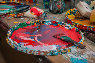 Bright colors in the artist's palette and a brush in an art workshop