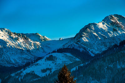 View of snowcapped mountain against blue sky