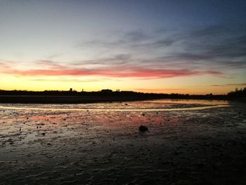 Scenic view of beach at sunset