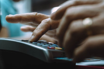 Close-up of person using credit card reader at store