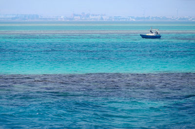 Sailboat sailing on sea against sky