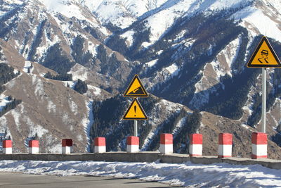 Road sign on snow covered mountain