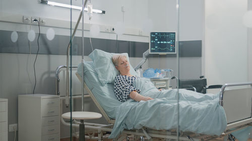 Portrait of female doctor examining patient at clinic