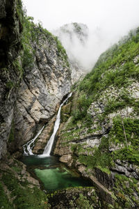 Scenic view of waterfall in mountains