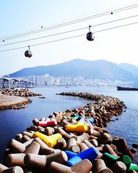 Stones by sea against sky