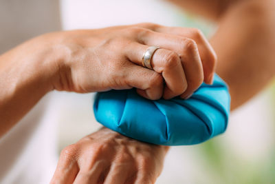 Wrist pain treatment. woman holding ice bag compress on a painful wrist.