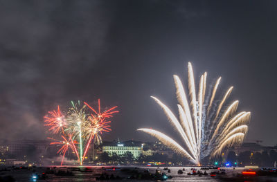 Low angle view of firework display at night