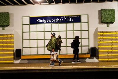 People walking on railroad station platform