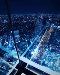 High angle view of illuminated buildings in city at night