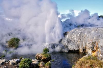 Scenic view of waterfall against sky