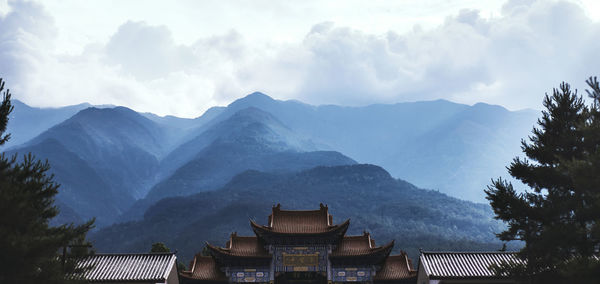 Panoramic view of buildings and mountains against sky