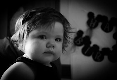 Close-up portrait of cute girl at home