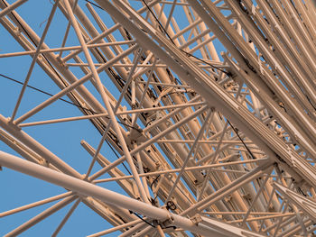 Low angle view of metallic structure against blue sky