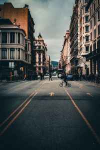City street and buildings against sky