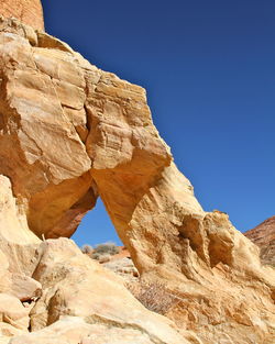 Low angle view of rock formation against clear sky